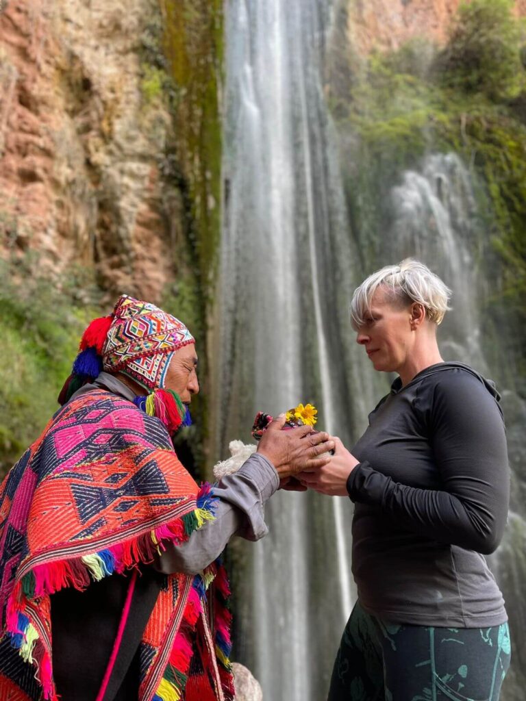 Woman and shaman in front of Waterfall - Nature Trips Peru