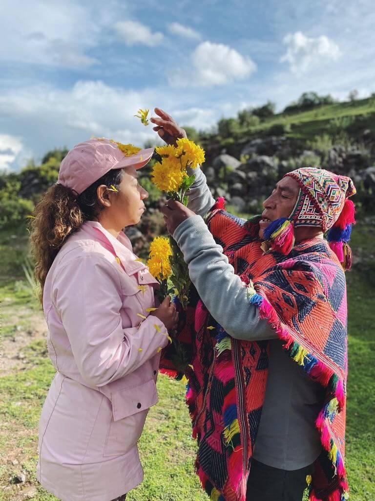 shaman performing flower cleansing on girl