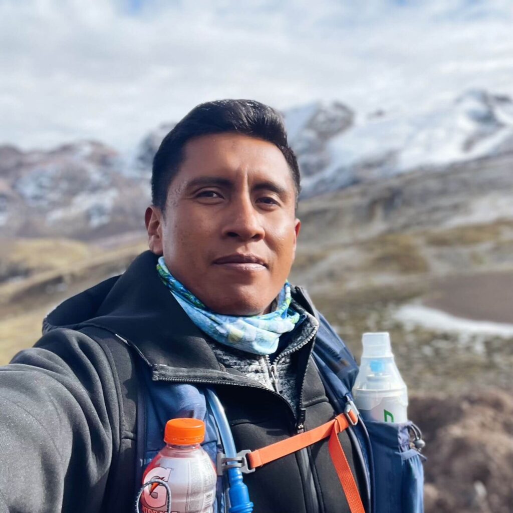 Peruvian man posing in front of mountain